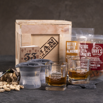 Personalized Whiskey Crate includes two personalized rocks glasses, ice sphere molds, coasters, snack assortment, and drinking journal.
