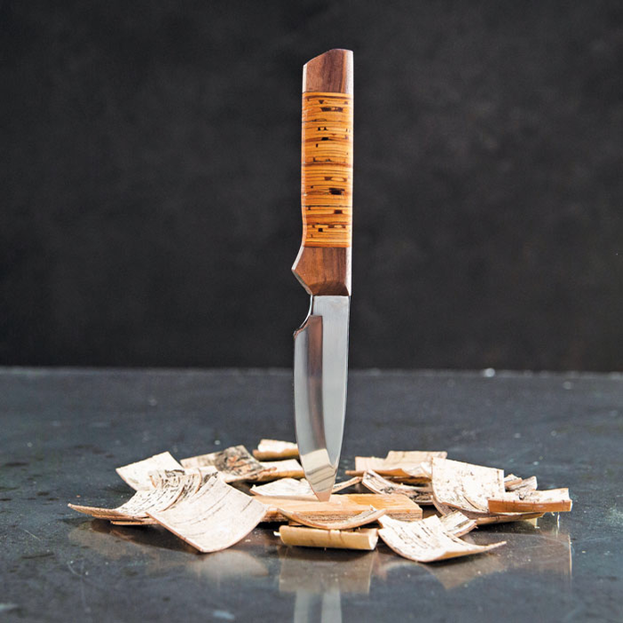 complete birchbark hunter knife sticking into a pile of wood pieces for a great men's DIY gift.
