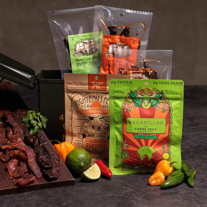 Assorted Spicy Jerky packages sticking out of an ammo can is a great men's snack gift.