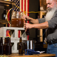 Man with beard adjusting brew kit for men's DIY gift.